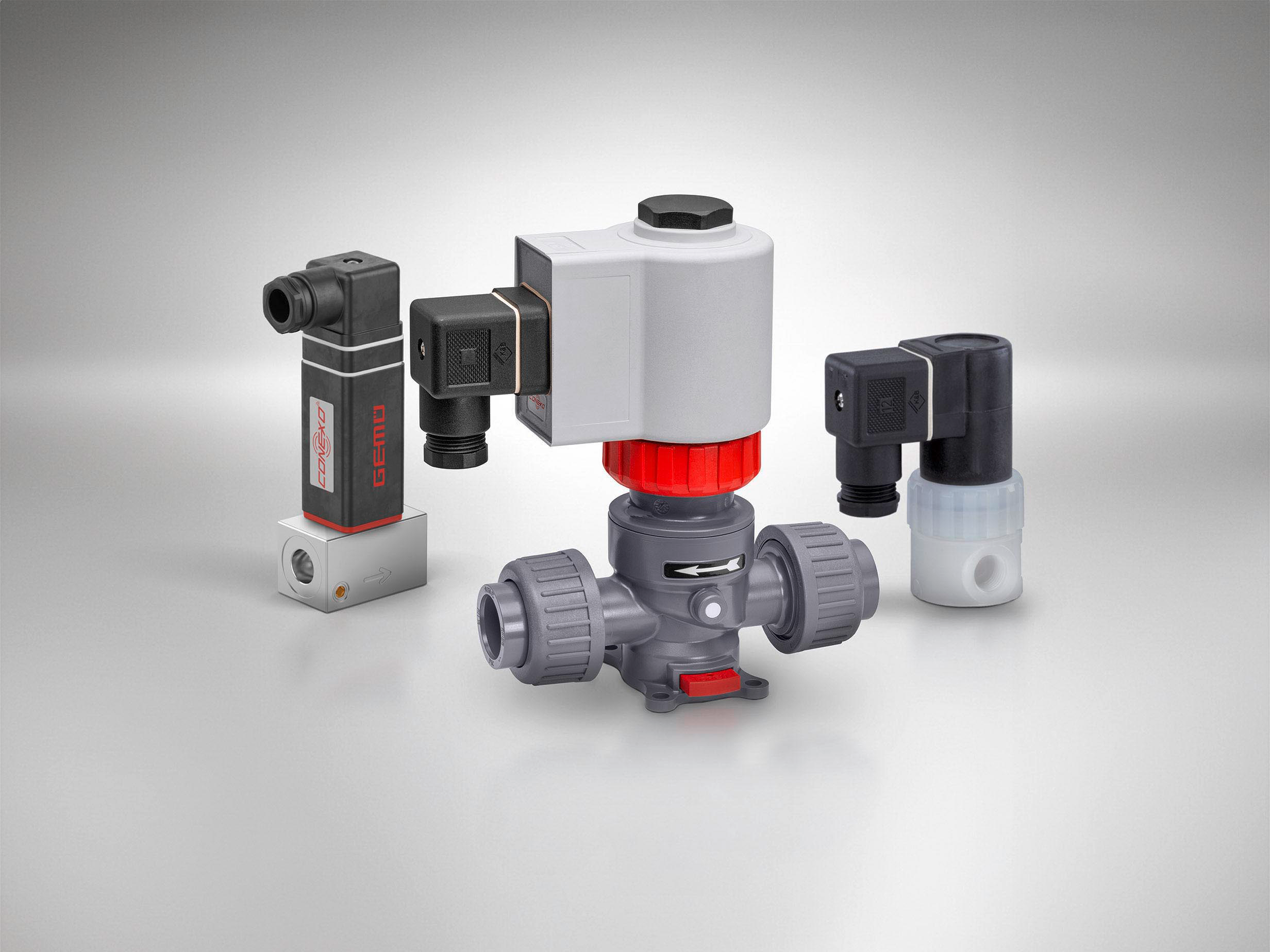 Three different GEMÜ solenoid valves for process applications.